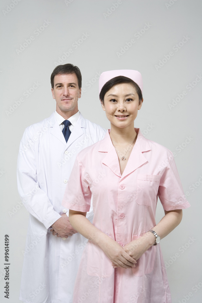 Doctor with nurse in pink uniform