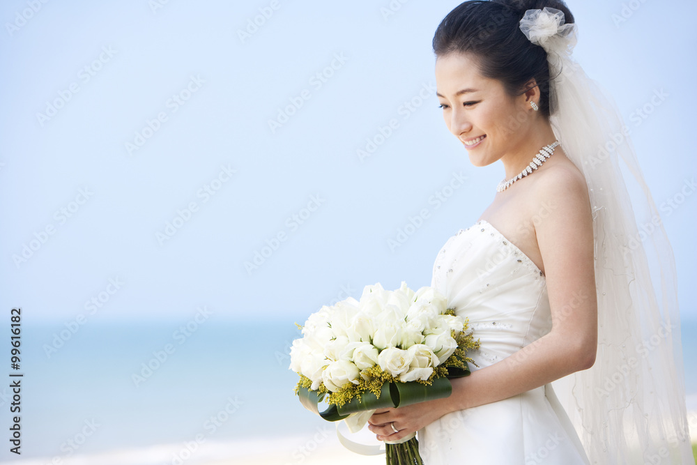 Happy bride relaxing on the beach