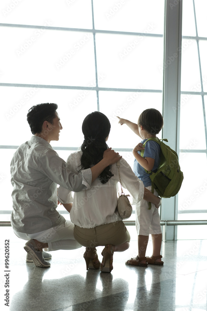 Young family looking at view at the airport