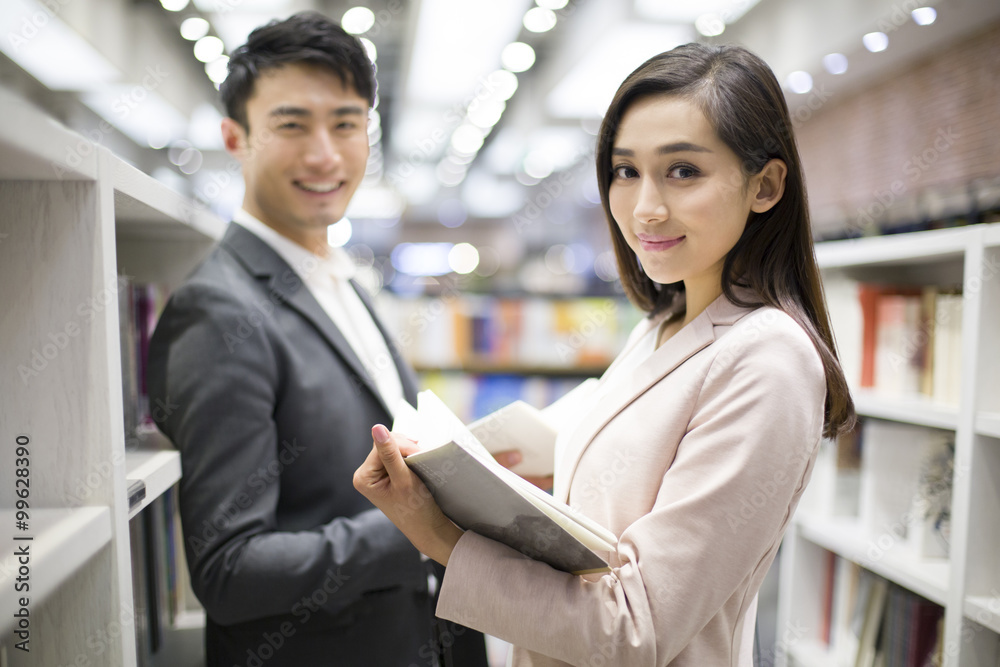 Young couple choosing books in bookstore