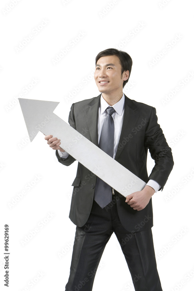Young businessman holding arrow