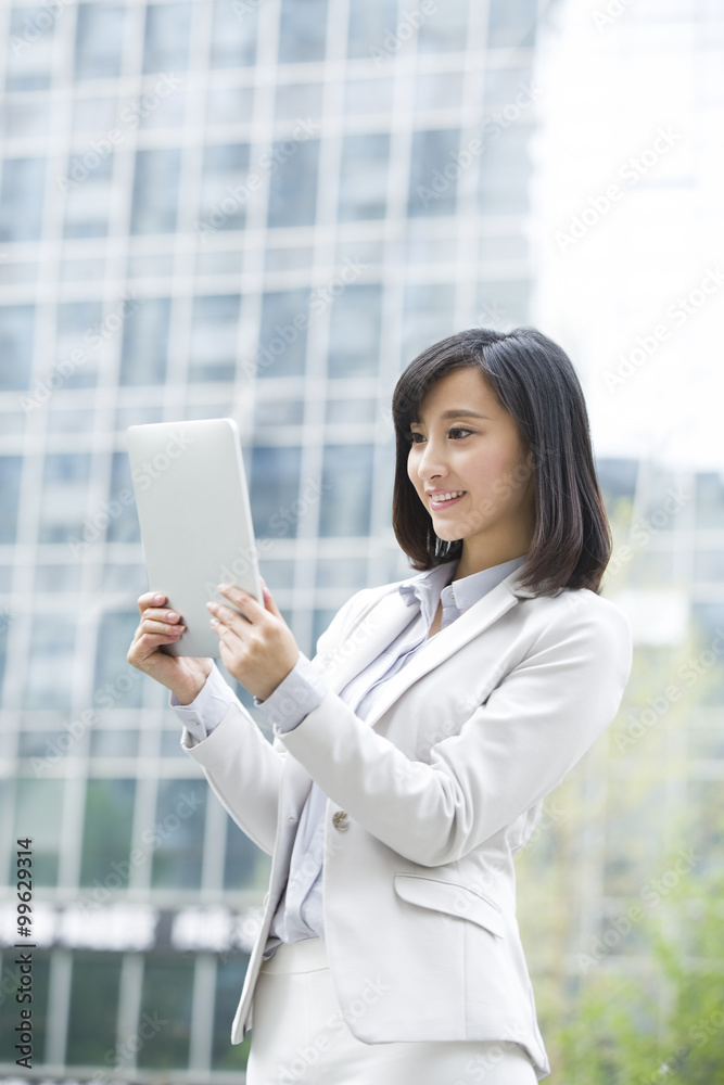 Young businesswoman using digital tablet