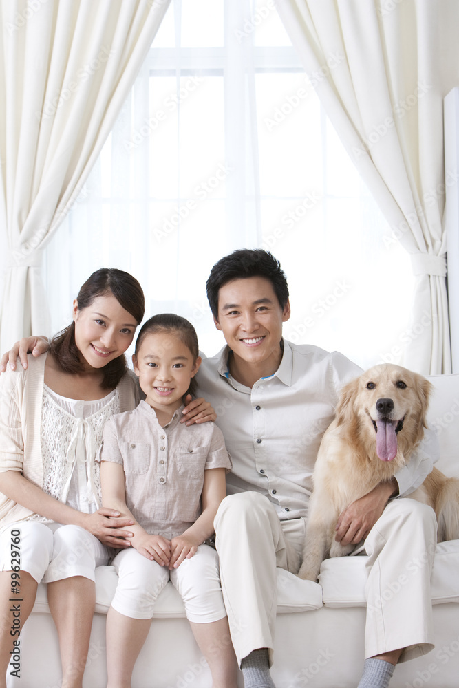 Happy family and dog on sofa