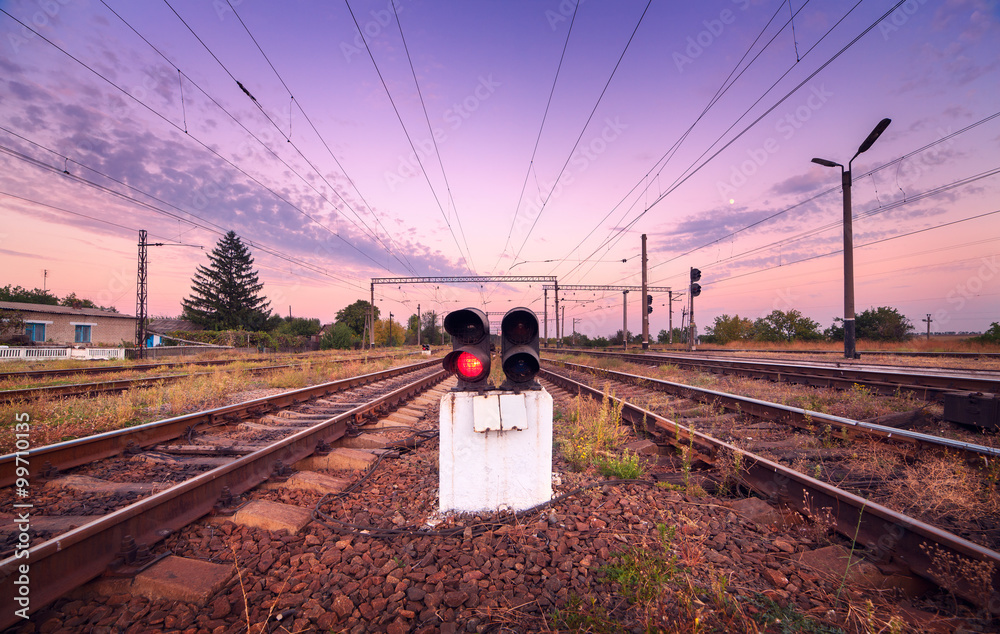 Train platform and traffic light at sunset. Railroad. Railway st