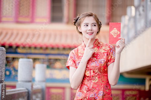 chinese new year girl with ang pow red packet, with decorations on background
