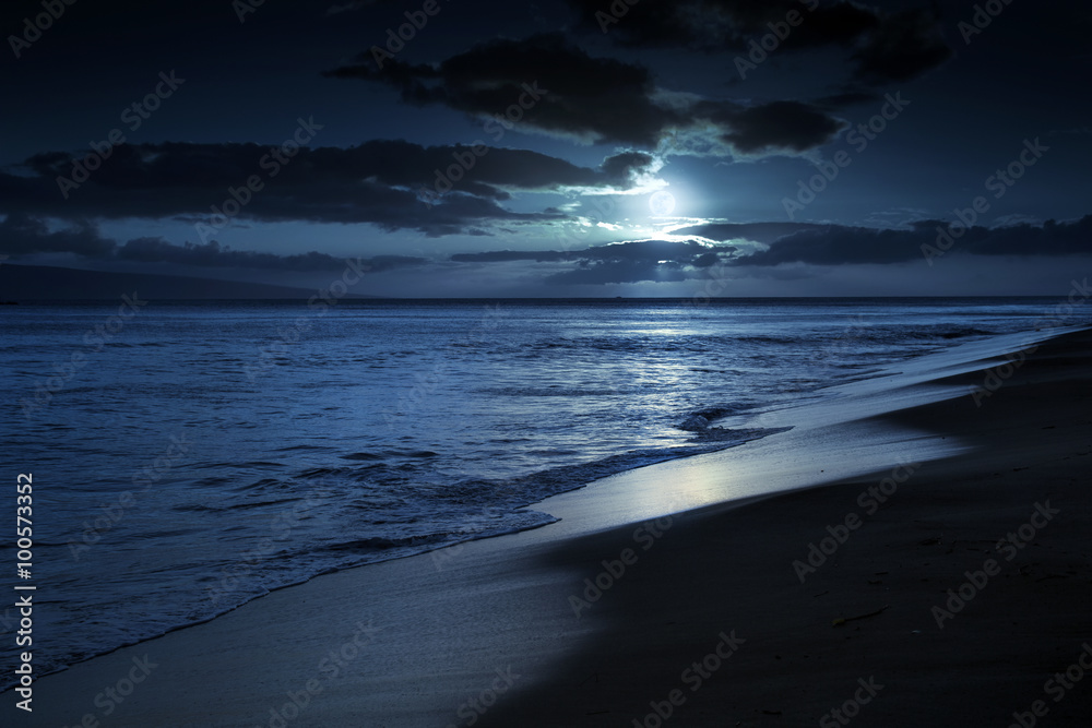 This photo illustration depicts a quiet and romantic moonlit beach in Maui Hawaii.