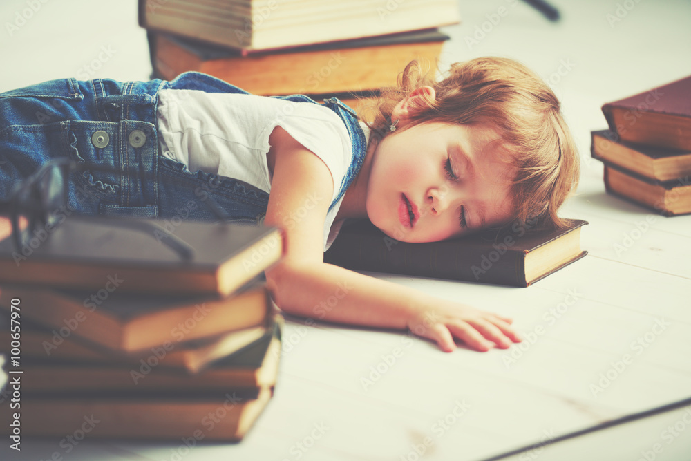 tired little girl fell asleep for books
