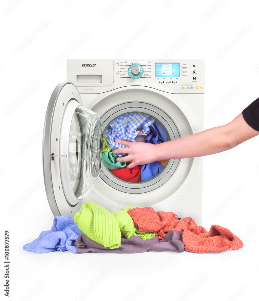 A close up of a washing machine loaded with clothes