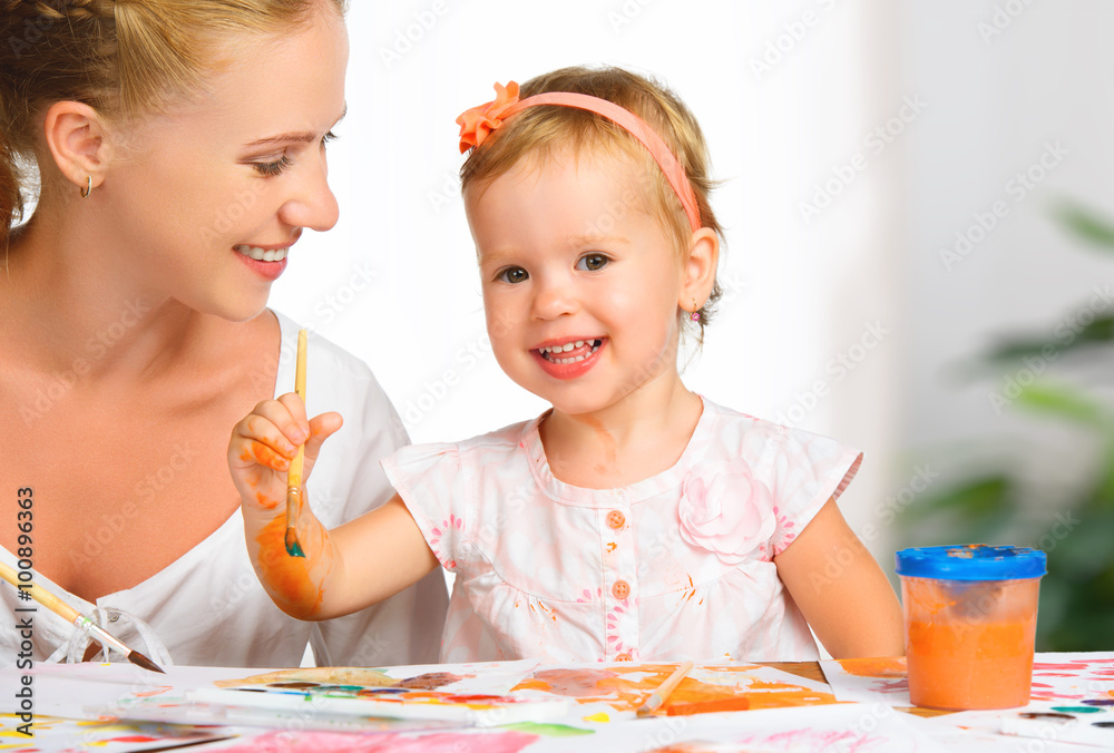 mother and child  daughter draw paints