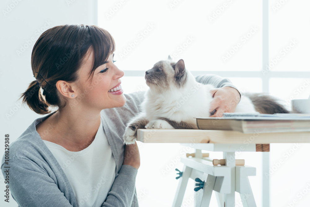 Happy woman cuddling her cat