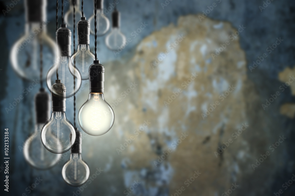 Idea and leadership concept Vintage  bulbs on wall background