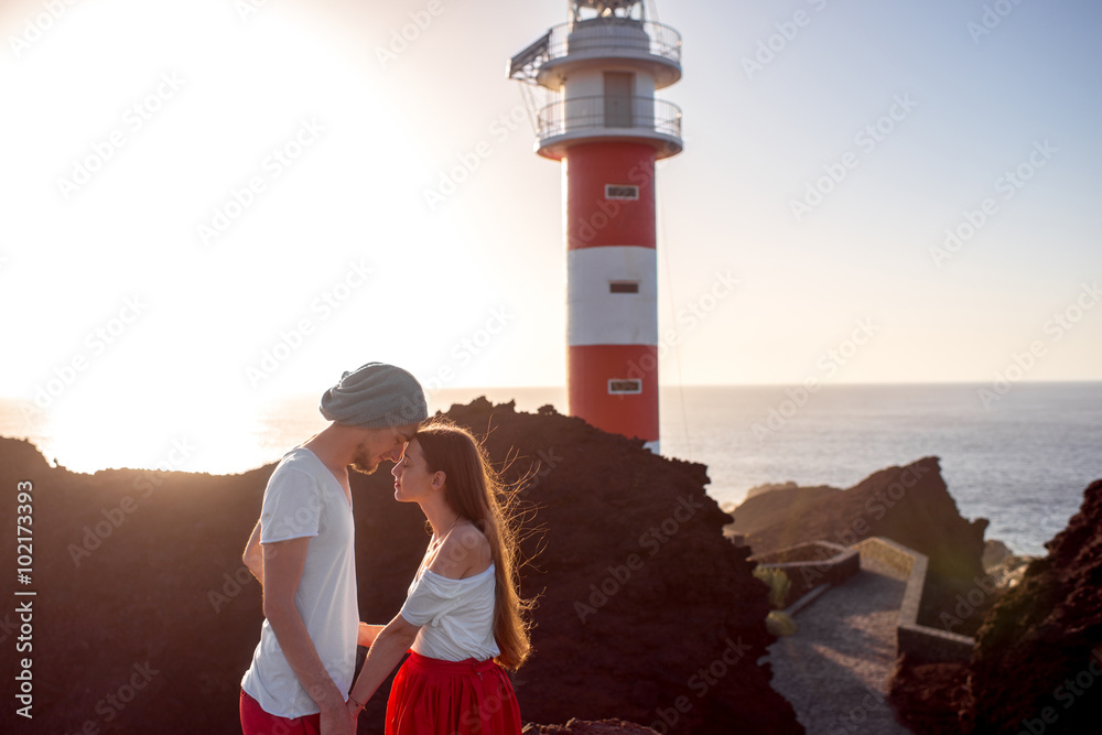 Couple standing together near the lighthouse
