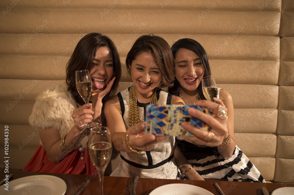 Three women have taken on a smartphone with a champagne