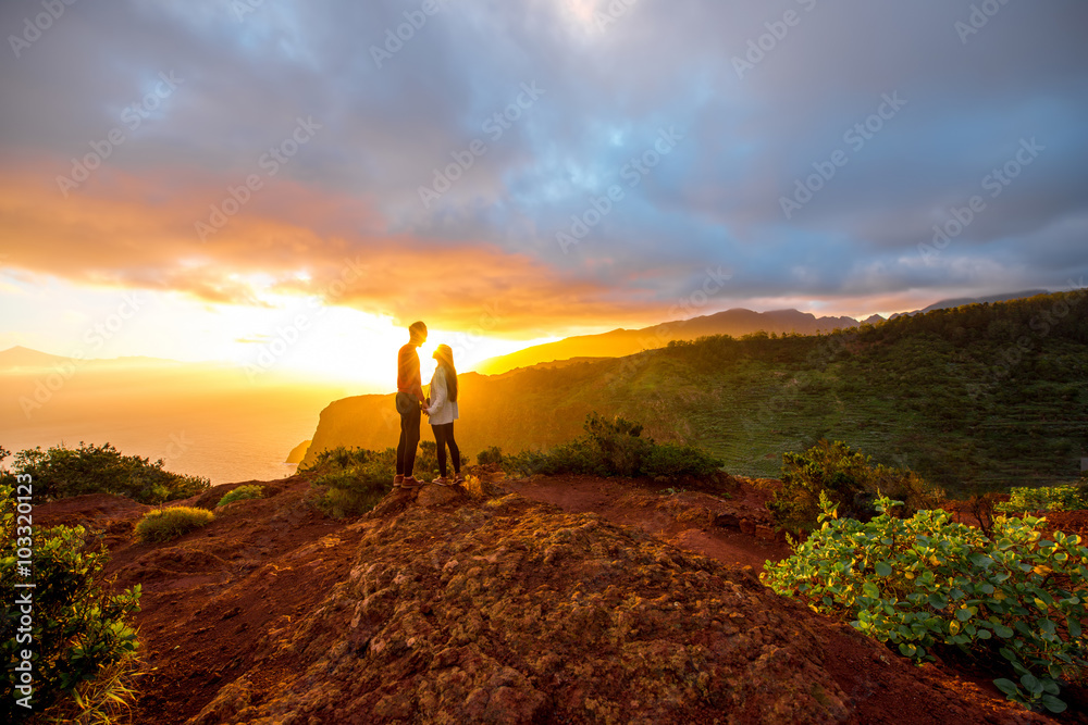 Couple enjoying beautiful sunrise