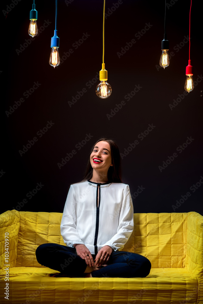 Woman on the couch with illuminated lamps