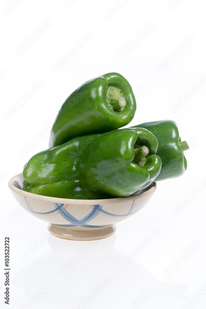 green pepper in a bowl isolated on white background