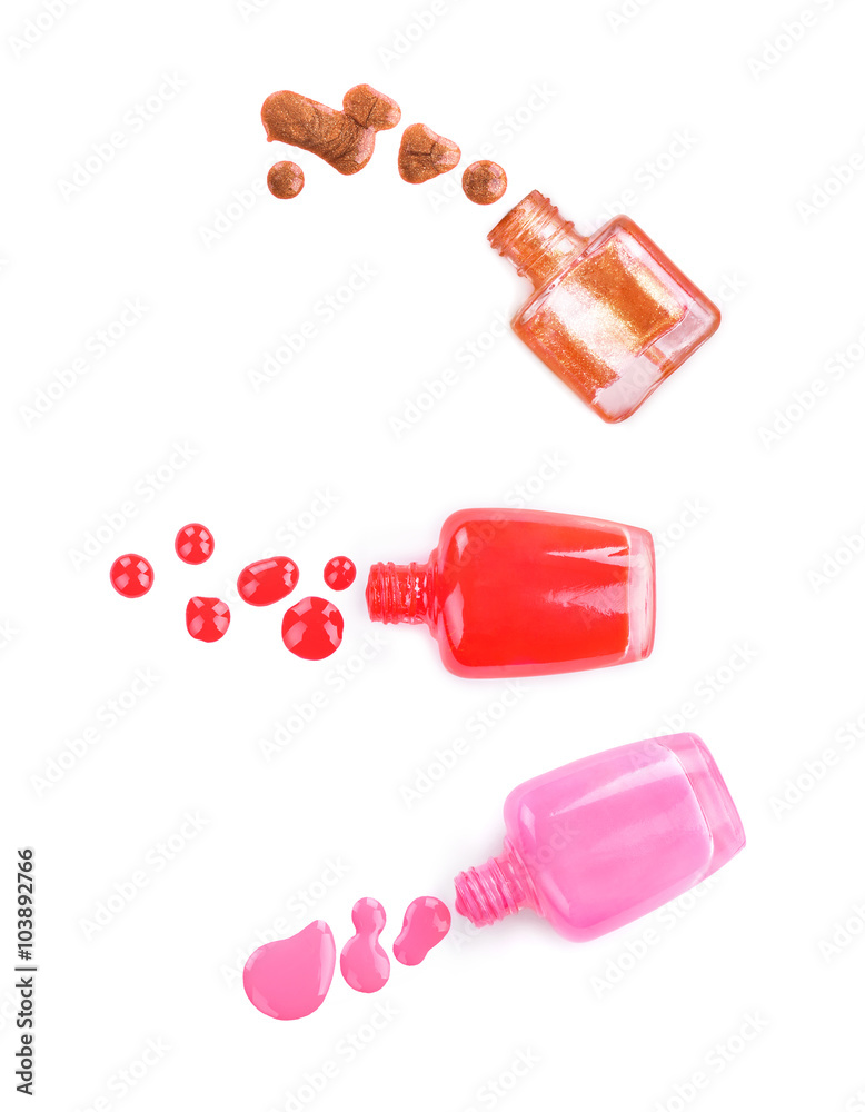 collection of various nail polish bottle and drop on white backg