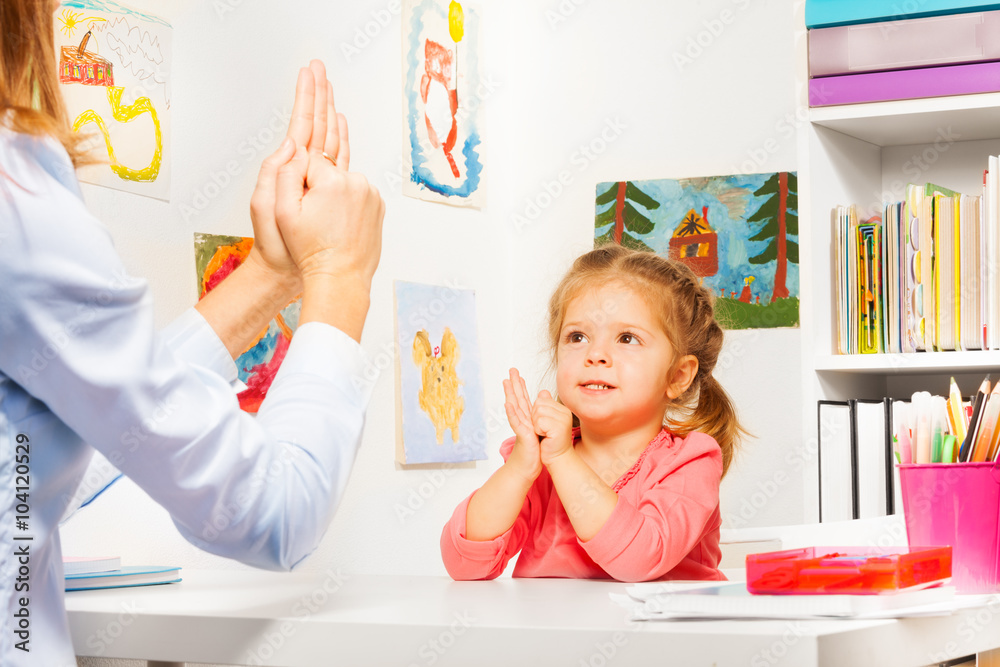 女孩和老师玩手指游戏