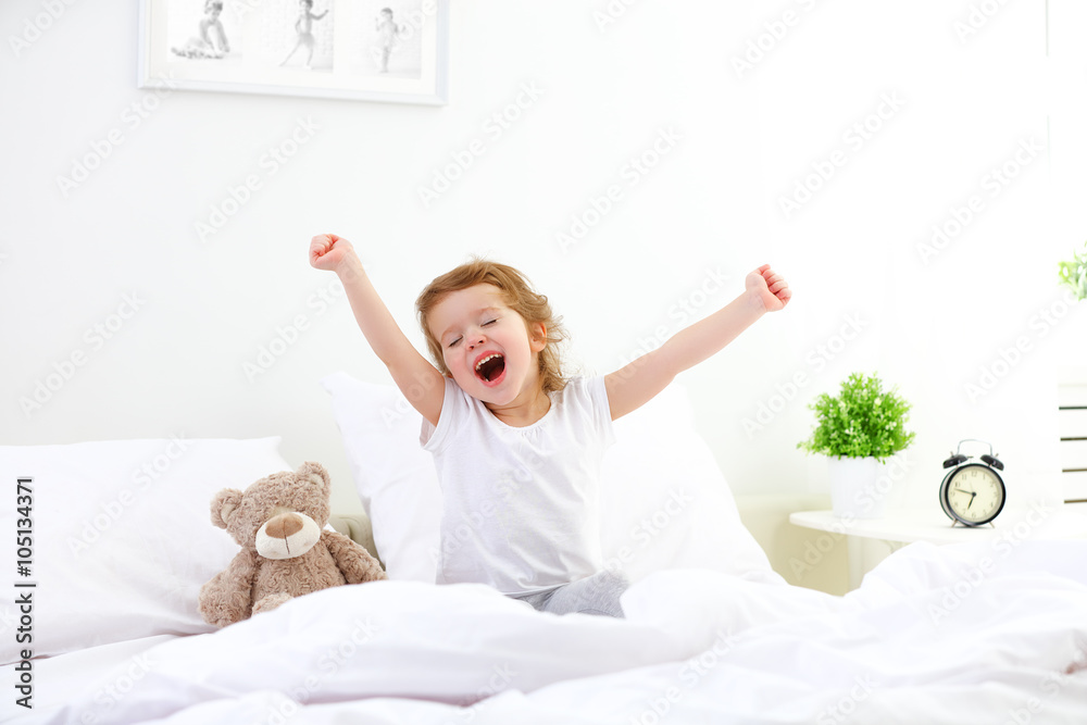 morning awakening child girl in bed