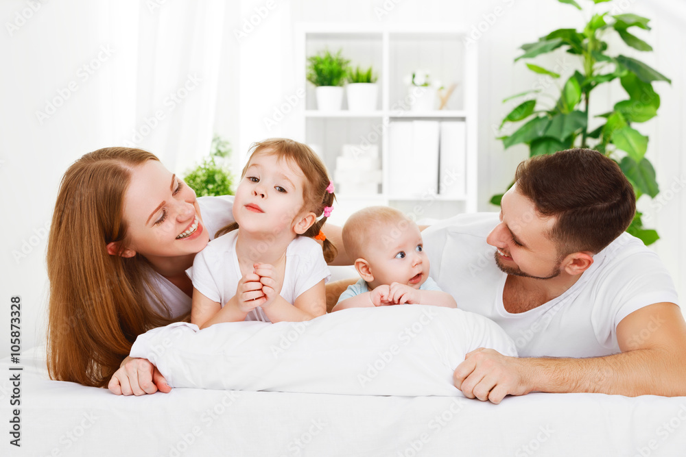 happy family at home in  the bed