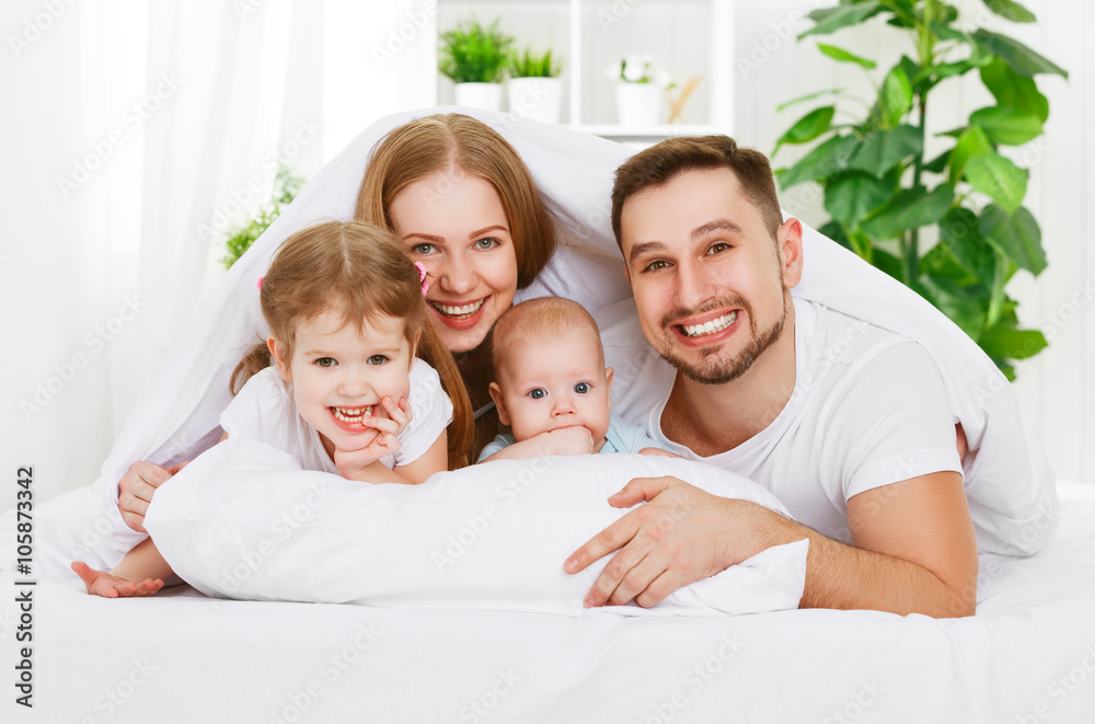 happy family at home in  the bed