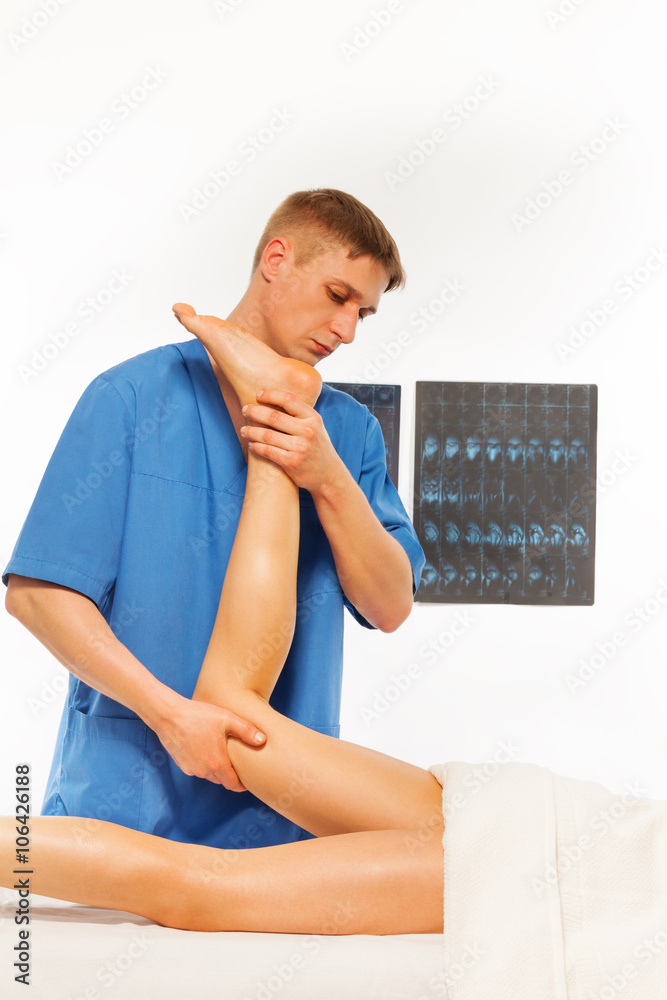 Physical therapist doing massage on woman leg
