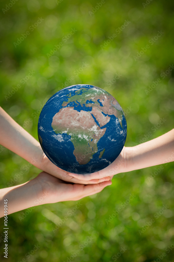 Children holding Earth planet in hands