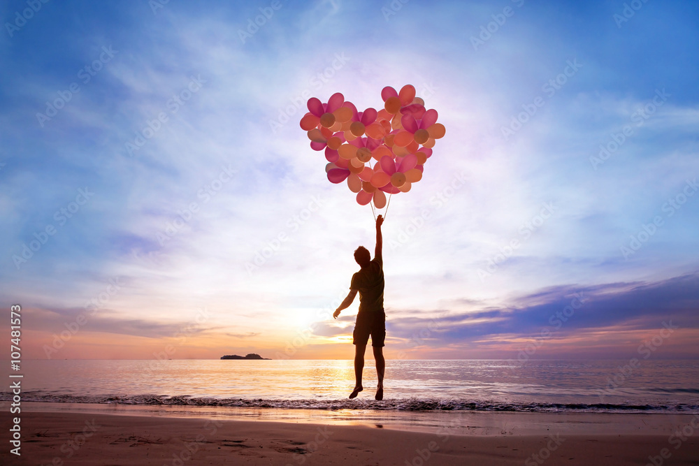 love concept, man flying with heart from balloons, fall in love