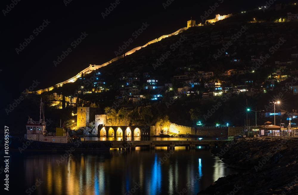 Night view of harbour, fortress and ancient shipyard in Alanya, Turkey.