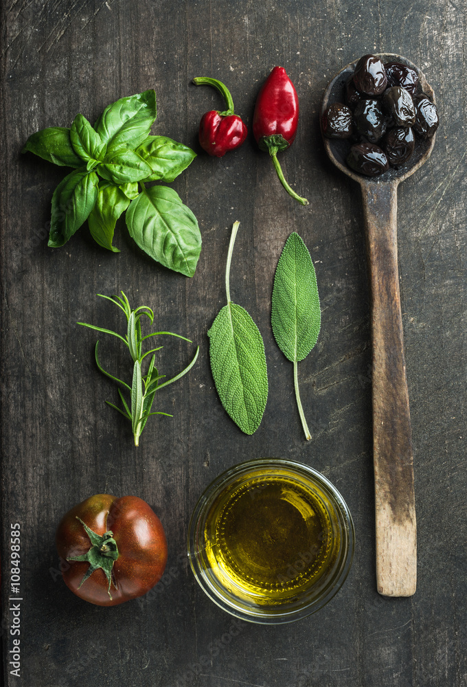 Vegetables and herbs on dark rustic wooden background. Greek black olives, fresh green sage, rosemar