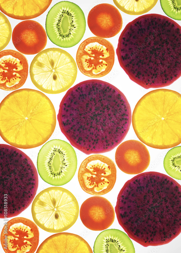 collection of fruits and vegetables on a white background , back lit .