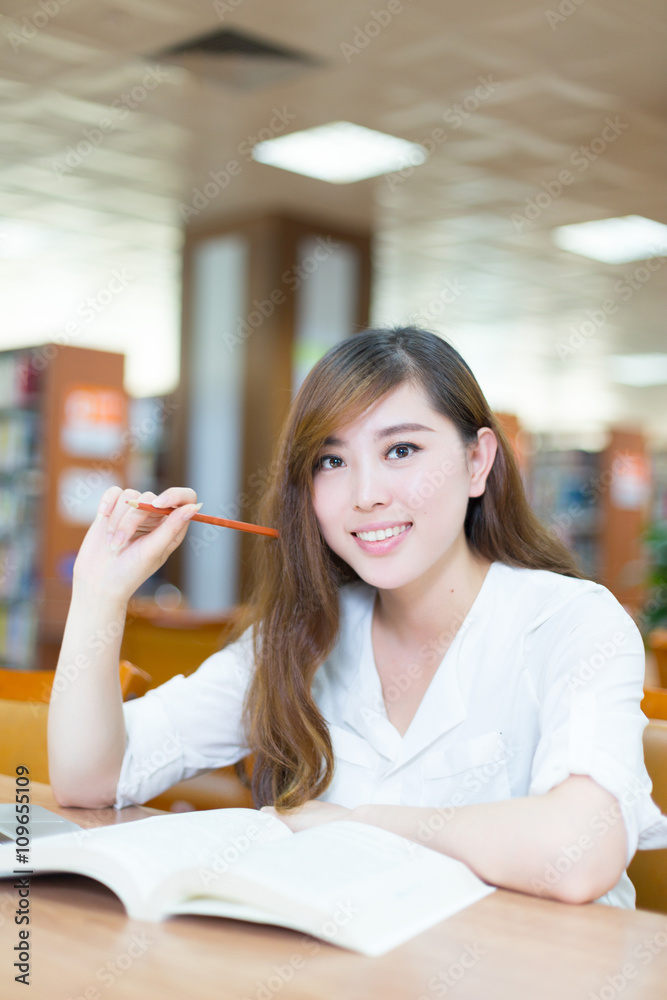 young beautiful asian girl student in library