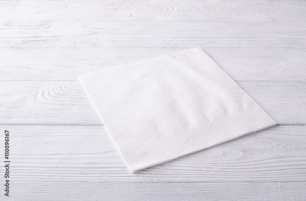 白色木桌上的白色餐巾。俯视图