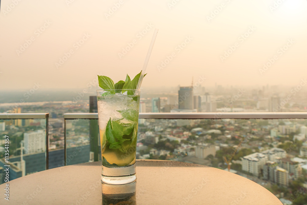 Mojito cocktail on table in rooftop bar. Rooftop bar in Bangkok,