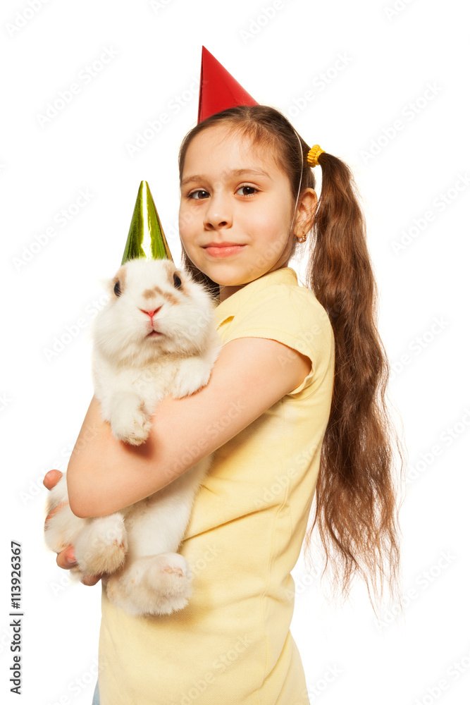Birthday girl smiling holding furry present bunny