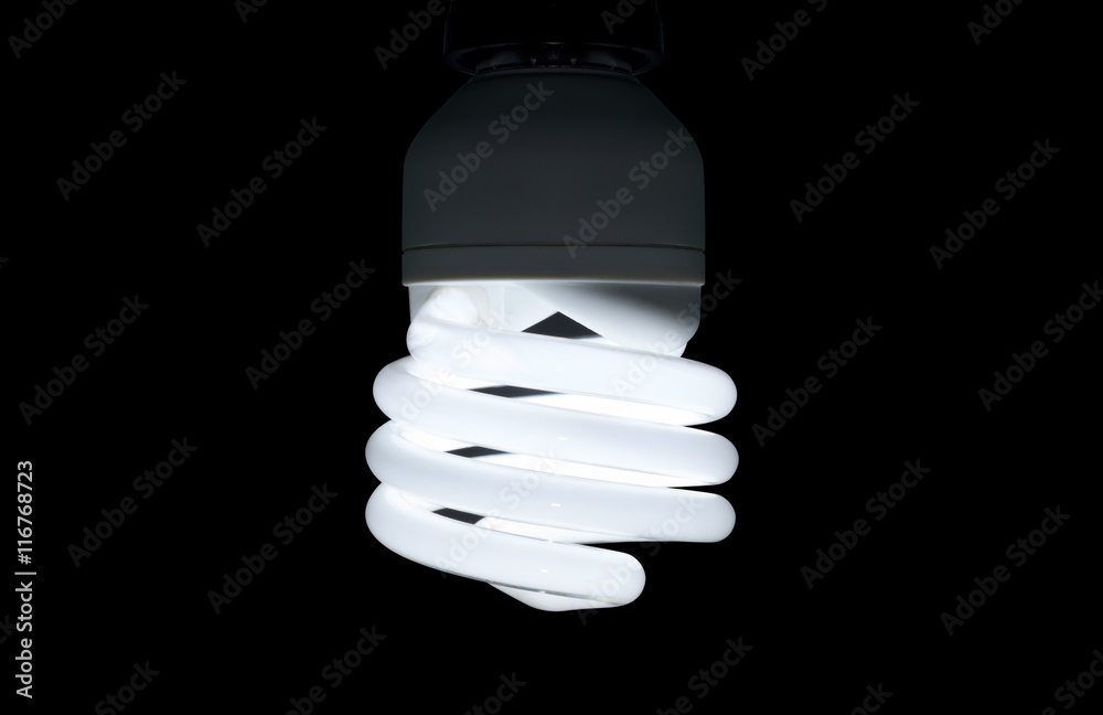 Illuminated light spiral bulb on black background
