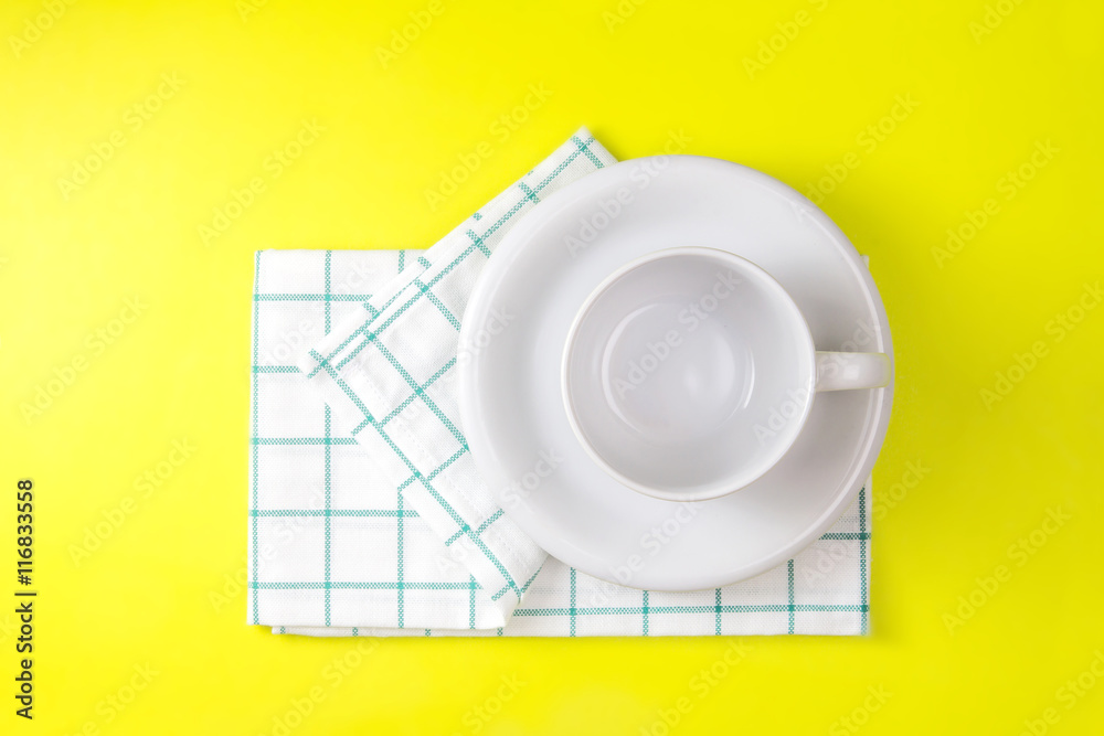 top view of empty white coffee or tea cup with towel 