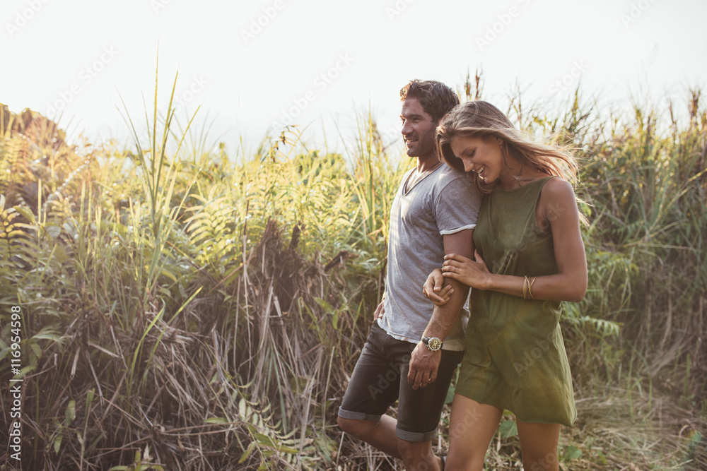 Romantic young couple walking together in countryside