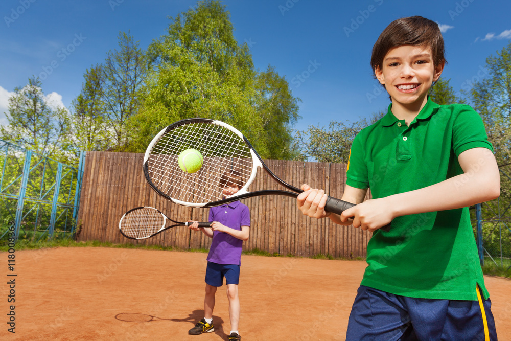 快乐的网球运动员和他的搭档在球场上