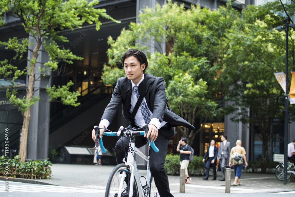 Cool businessman is riding the road bike
