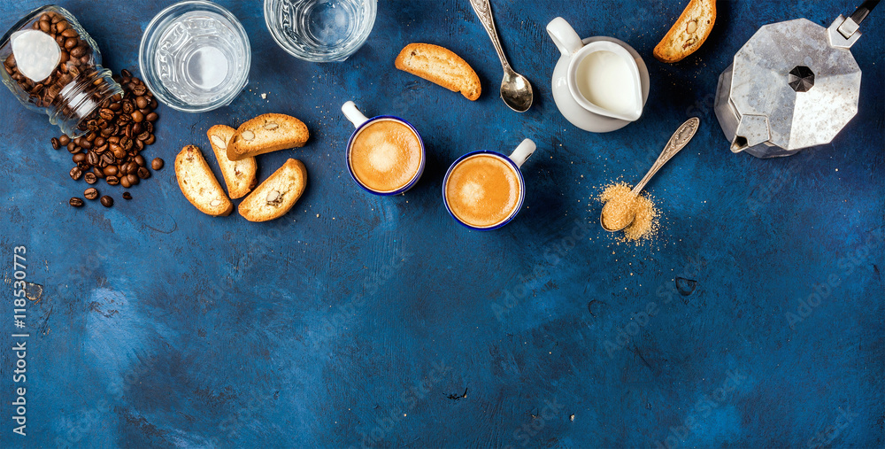 杯子里的意式浓缩咖啡，意大利康图奇，饼干和牛奶放在深蓝色的plywoo上
