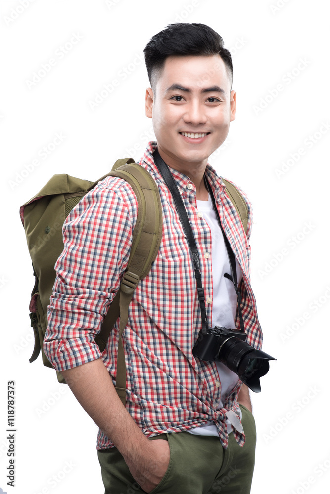 Travel concept. Studio portrait of handsome young man in hat wit
