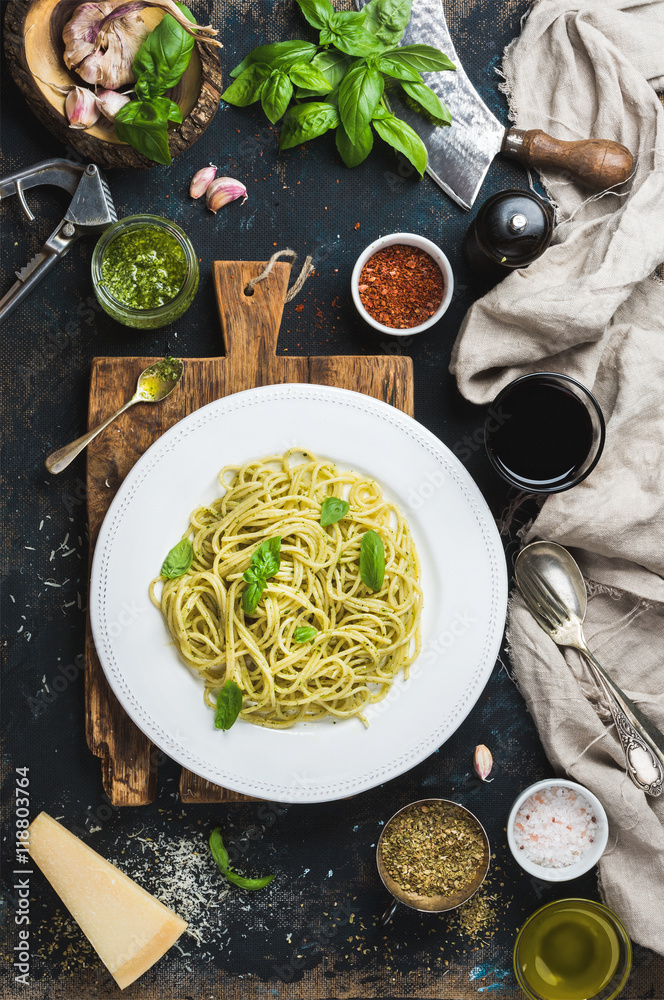 Italian pasta dinner. Spaghetti with pesto sauce and fresh basil, Parmesan cheese and spices served 