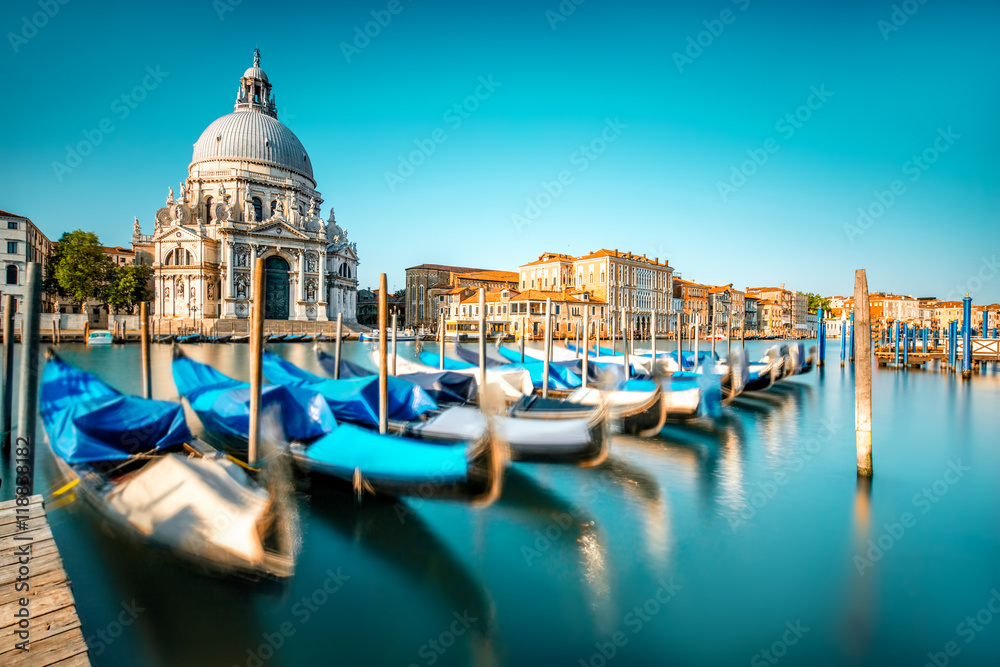 Venice cityscape view on Santa Maria della Salute basilica with gondolas on the Grand canal in Venic