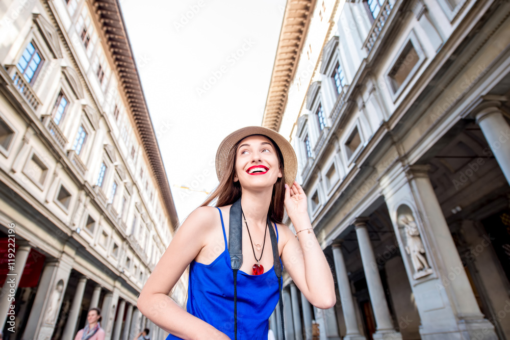 Young female traveler near famous Uffizi museum in Florence. Vacation in Italy
