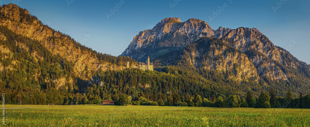 Alpine mountain landscape with famous Neuschwanstein Castleat sunset, Bavaria, Germany