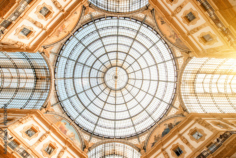 Interior with beautiful glass vaults in the famous Vittorio Emanuele shopping gallery in the center 