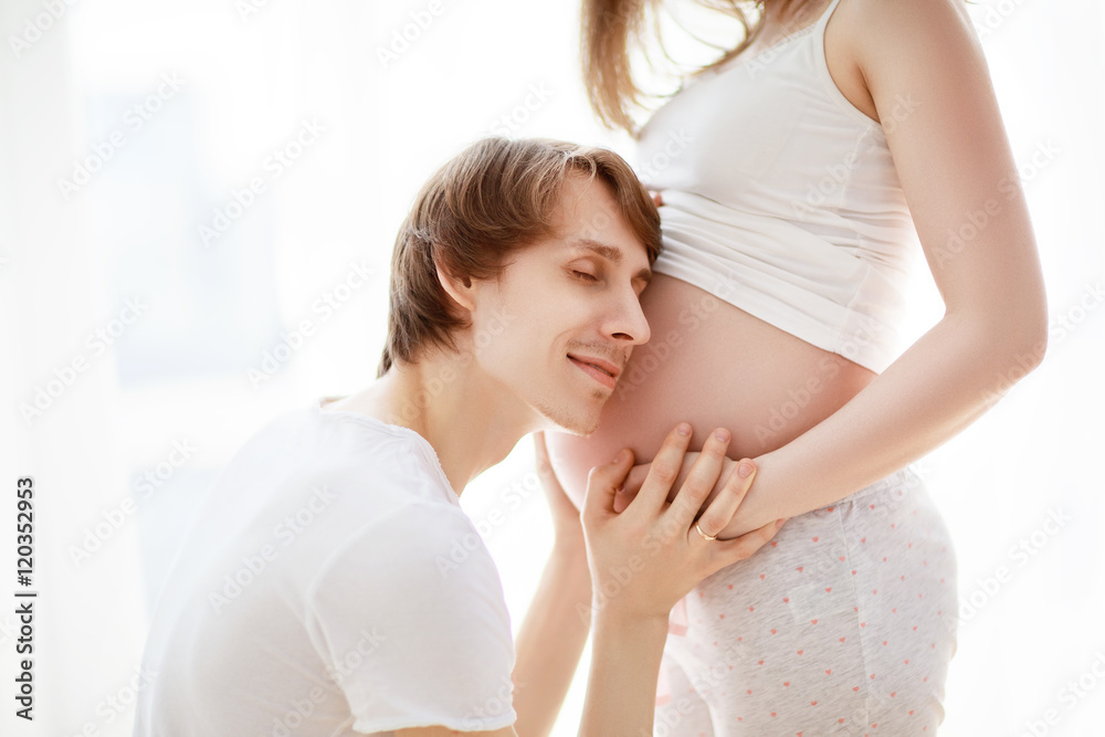 belly of pregnant woman and happy man future father