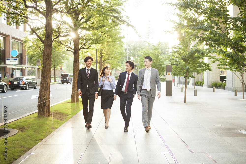 Young businessmen and women are walking the business district together