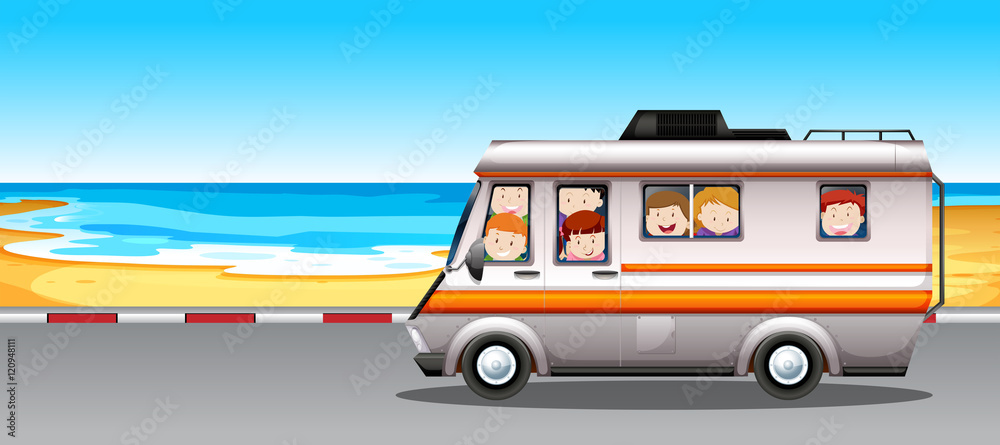 Children riding in camper van to the beach